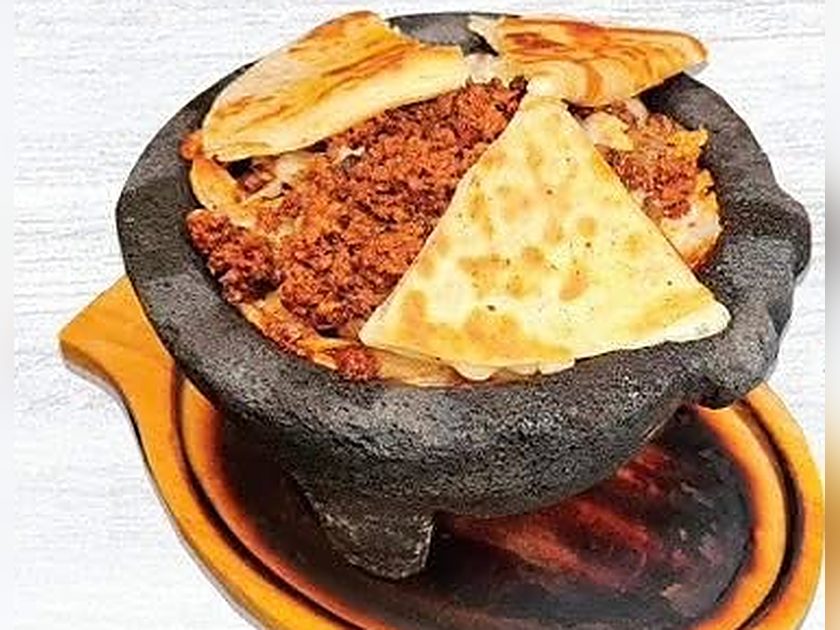 Molcajete served in a traditional hot stone bowl